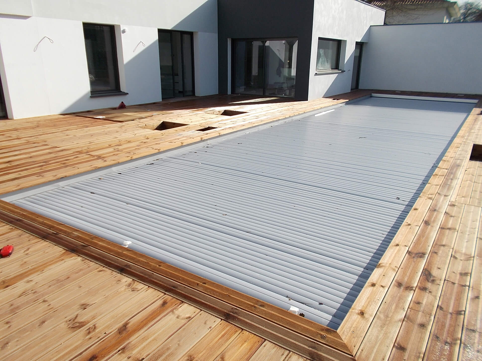 Terrasse bois et volet roulant piscine extérieure